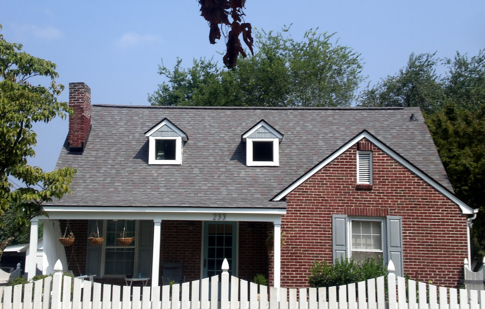 Full roof replacement, vented roofline, 50-year shingle, color-coordinated trim and chimney flashing.